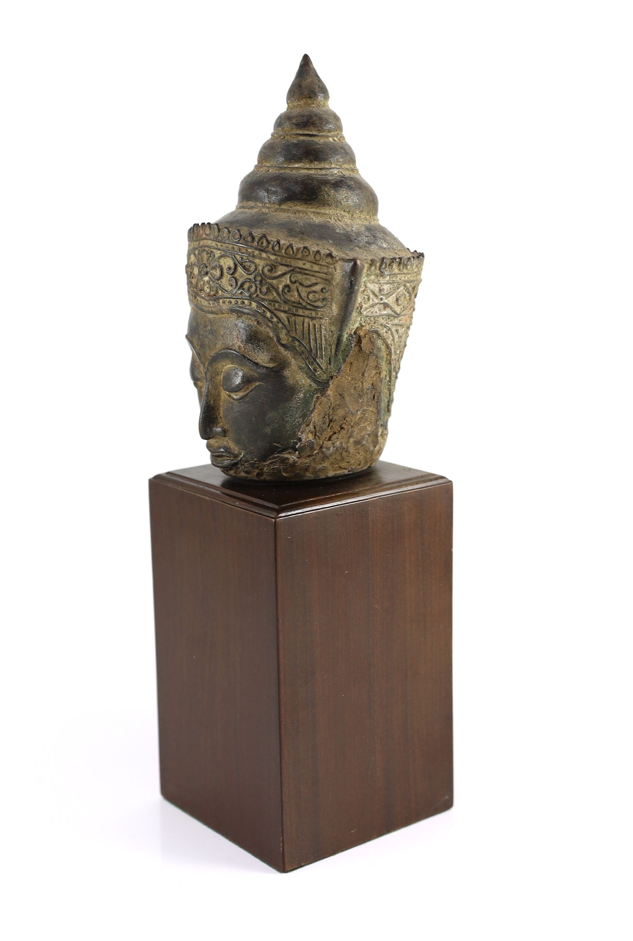 A Thai bronze crowned head of Buddha, 16th/17th century, 18cm high, excluding modern wood stand, ears lacking